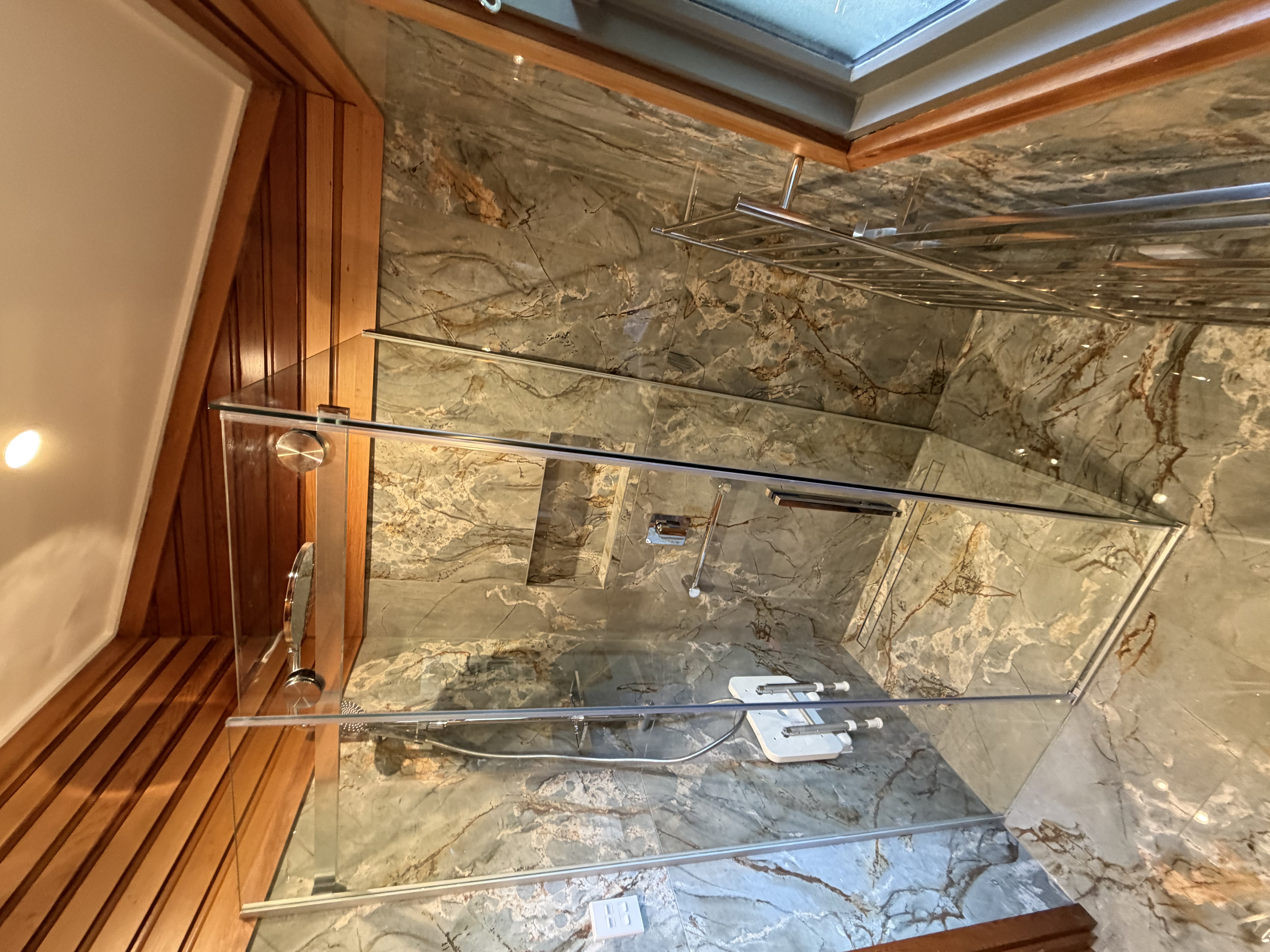 Luxury bathroom renovation with marble tiling and glass shower by Toomey Building, Dunedin